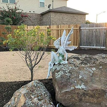 Statue of a sitting fairy in the garden