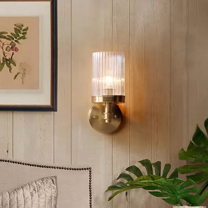 1-Light Wall Mounted Lamp Traditional Cylinder Transparent Glass Sconce Light in Brown/Gold over Bed | Kalsten