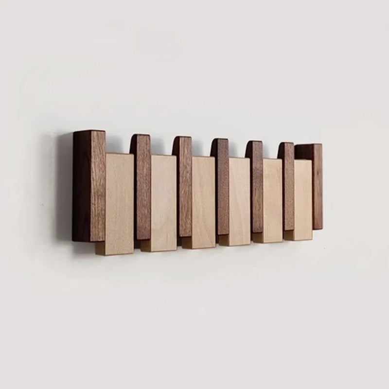 Wooden coat rack in piano design with foldable hooks | Kalsten