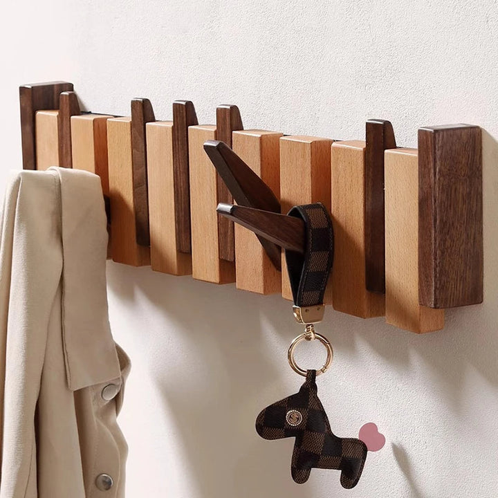 Wooden coat rack in piano design with foldable hooks | Kalsten