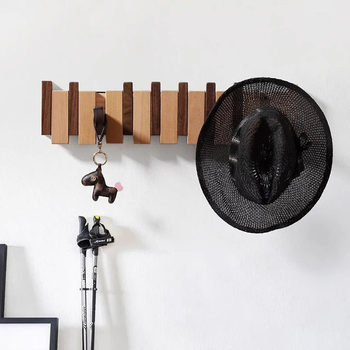 Wooden coat rack in piano design with foldable hooks | Kalsten