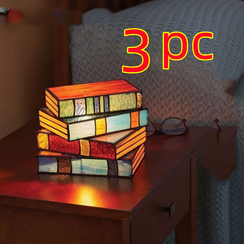 Desk lamp with stacked books | Kalsten