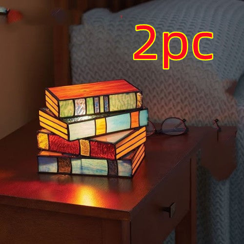Desk lamp with stacked books | Kalsten