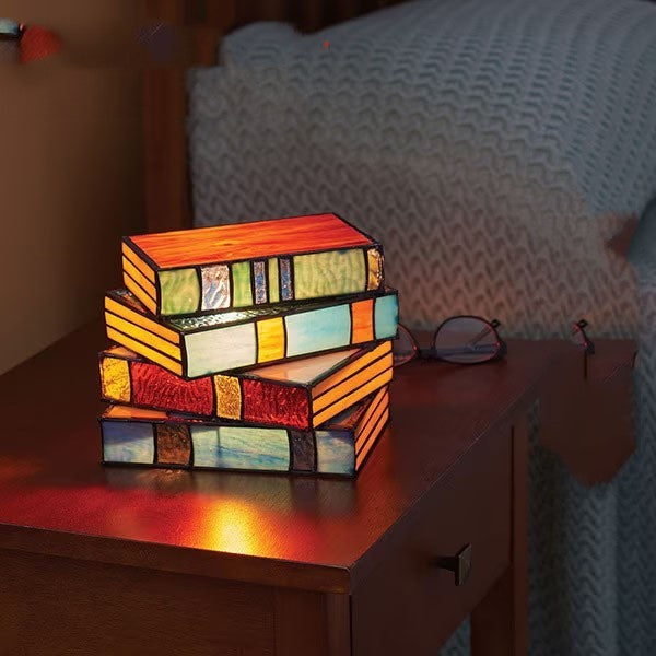 Desk lamp with stacked books | Kalsten