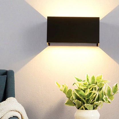 Modern, waterproof, rectangular outdoor LED wall light with up and down lighting.