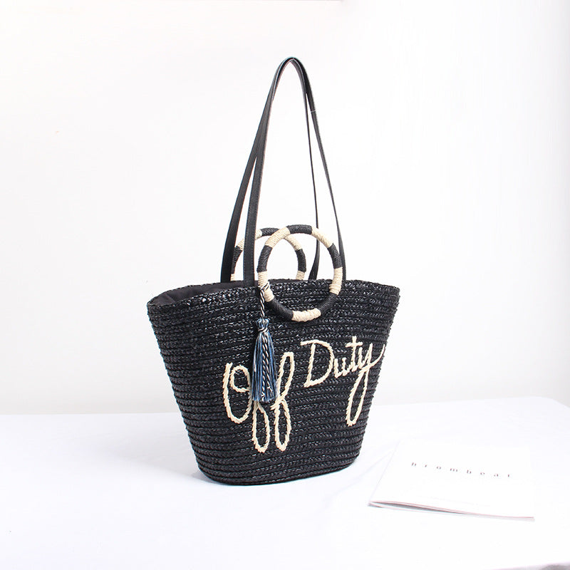 Designer shoulder bag with playful lettering and decorative tassel detail Kalsten