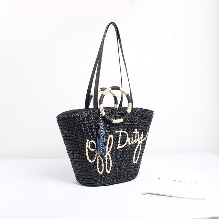 Designer shoulder bag with playful lettering and decorative tassel detail Kalsten