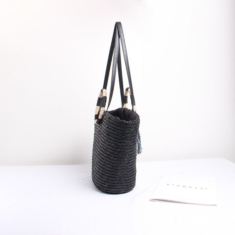 Designer shoulder bag with playful lettering and decorative tassel detail Kalsten