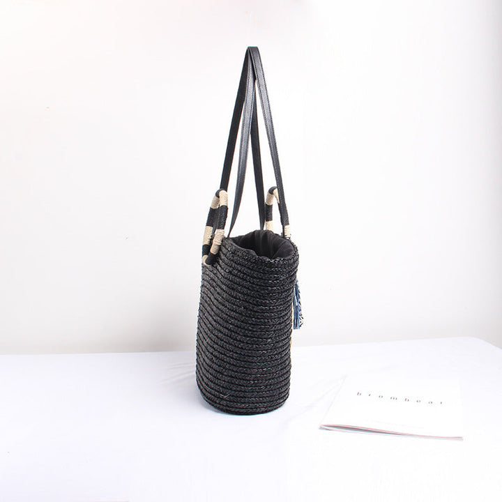 Designer shoulder bag with playful lettering and decorative tassel detail Kalsten