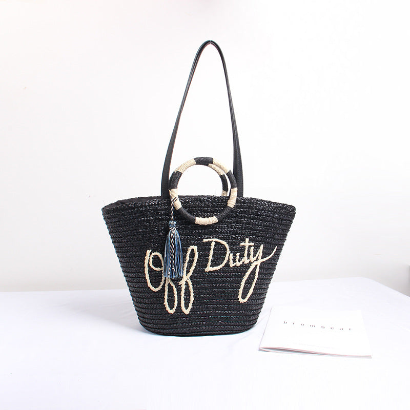Designer shoulder bag with playful lettering and decorative tassel detail Kalsten
