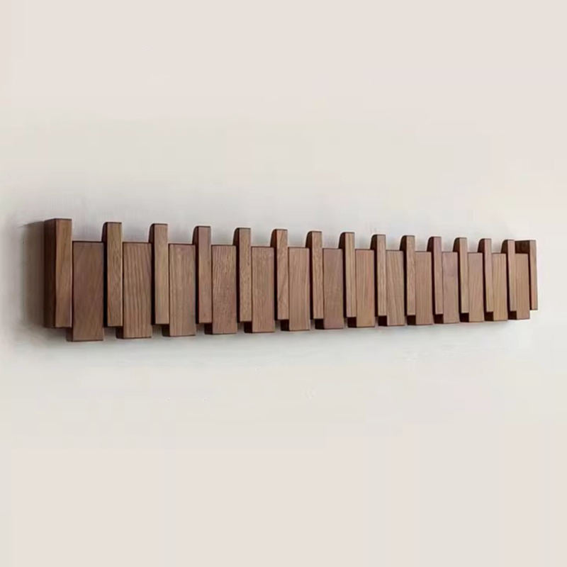 Wooden coat rack in piano design with foldable hooks | Kalsten