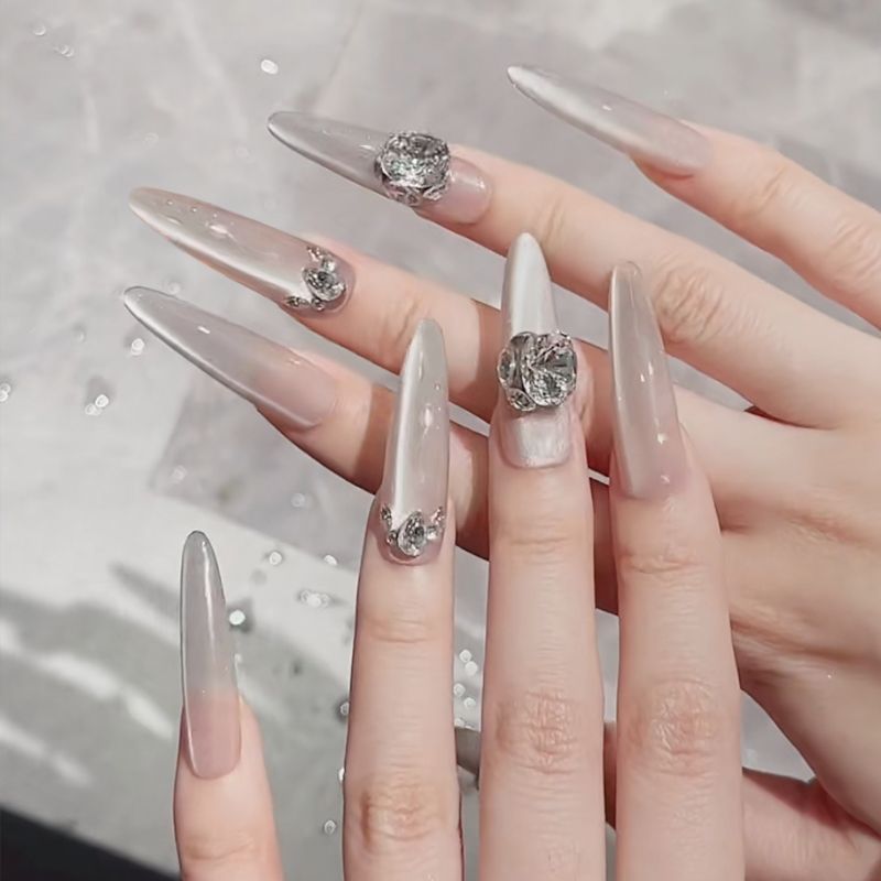 Acrylic nail set with elegant tips and glamorous rhinestone accents Acalora