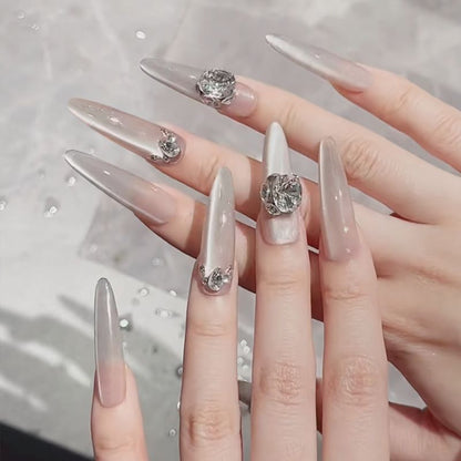Acrylic nail set with elegant tips and glamorous rhinestone accents Acalora