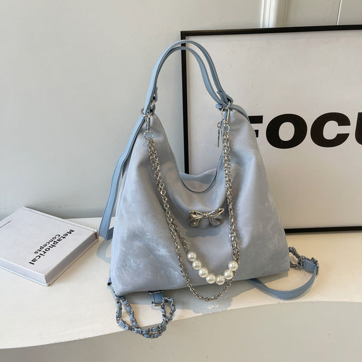 Fashionable handbag with unique pendant and chain accents Kalsten