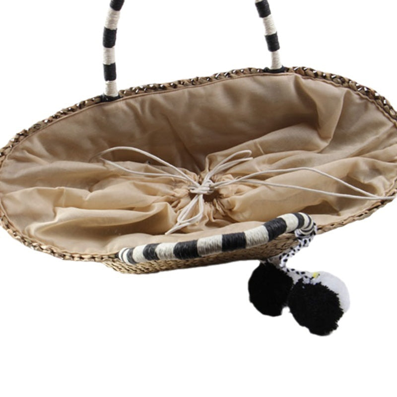 Braided beach bag with decorative pompons Kalsten