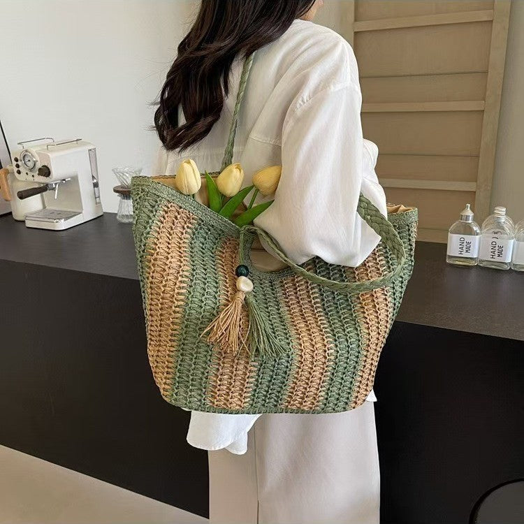 Handcrafted straw bag with elegant tassels and detailed texture Kalsten