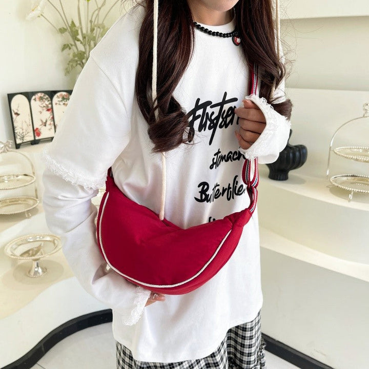 Fashionable shoulder bag with unique cut and adjustable strap Kalsten