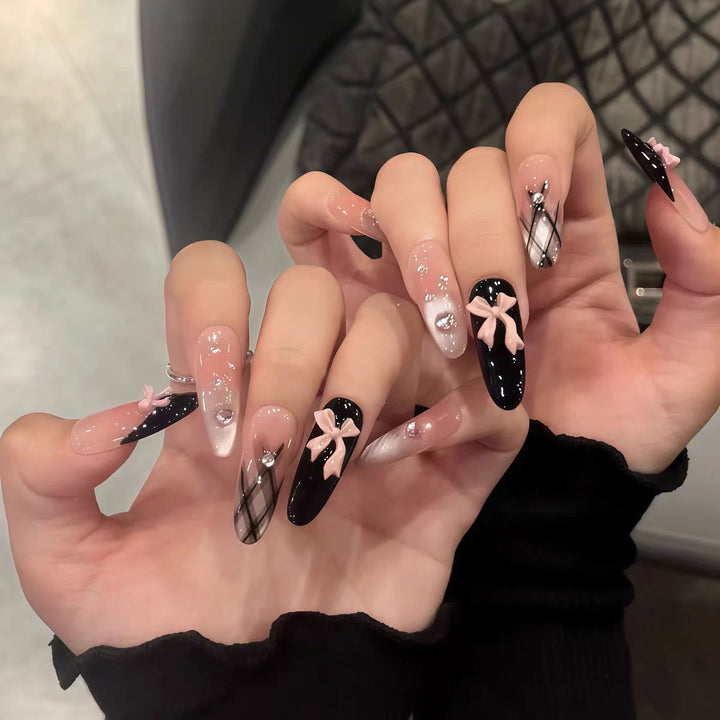 Artificial nails with playful bow design and glitter effects Kalsten