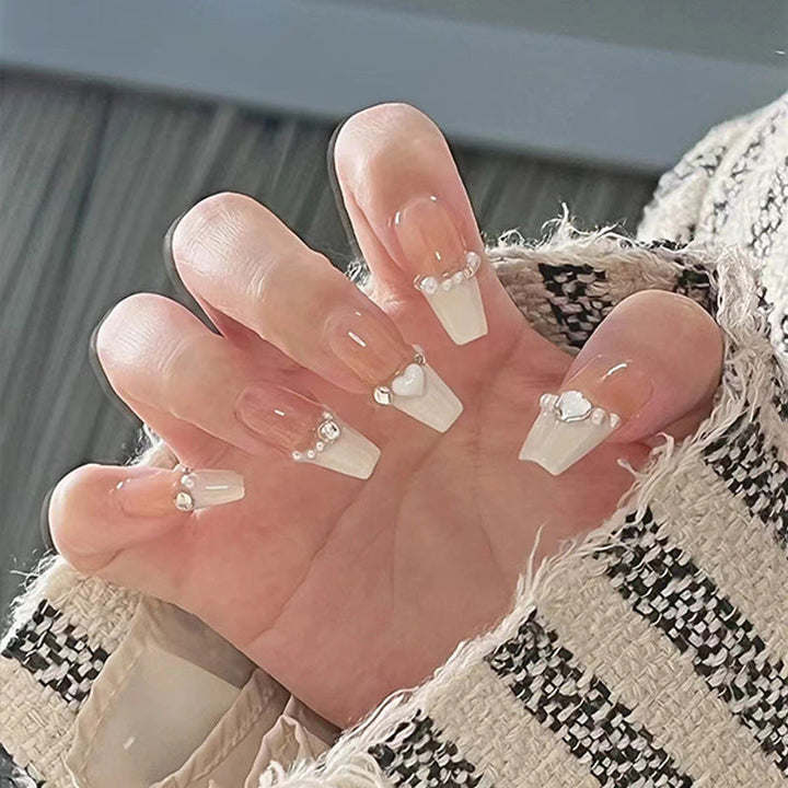 Glamorous artificial nails with heart design and glittering accents Kalsten