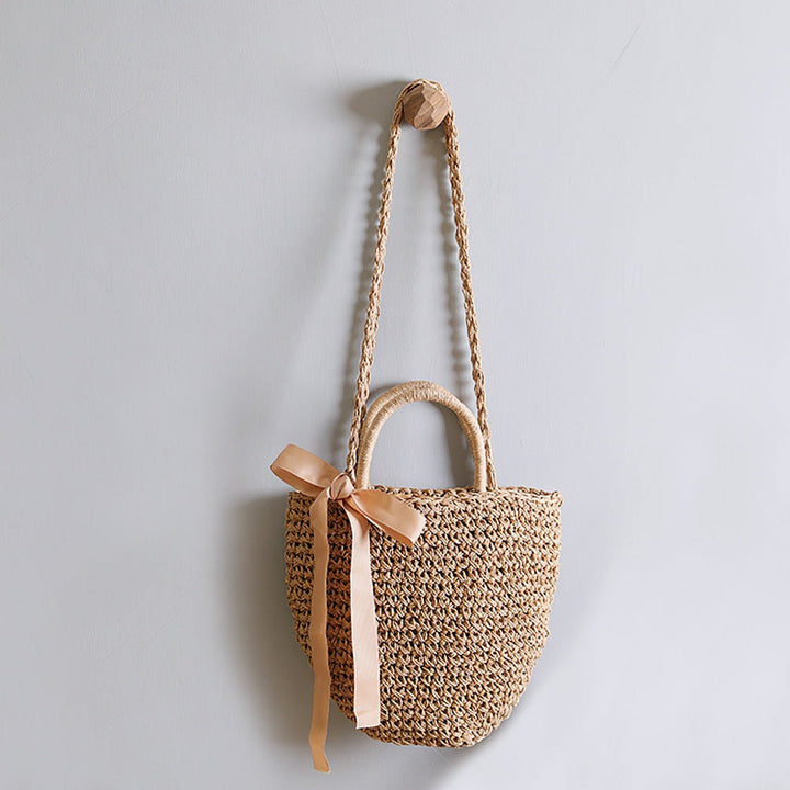 Basket bag with stylish carrying handles and decorative bow Kalsten