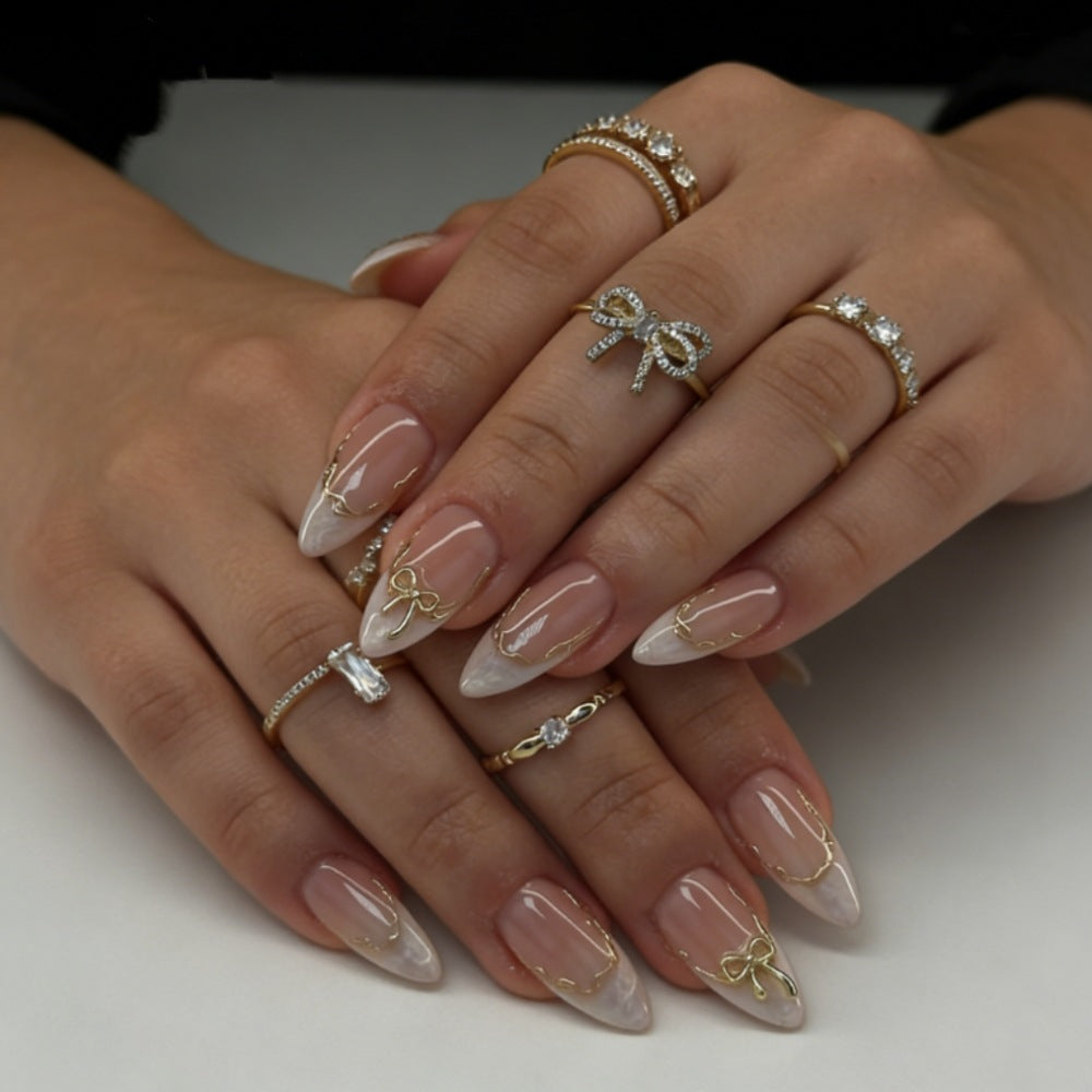 Artificial nails with elegant tip decorations and golden accents Kalsten