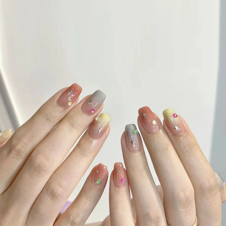 Glamorous artificial nails with heart design and glittering accents Kalsten