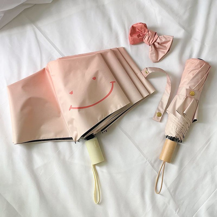 Women's foldable umbrella with playful design and handy wooden handle Kalsten