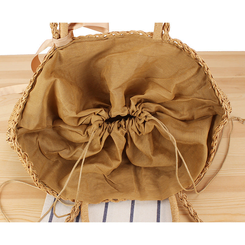 Beach bag made of natural raffia with playful design and elegant bow decoration Kalsten