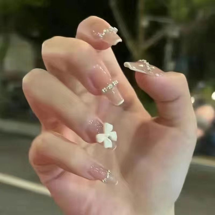 Glamorous artificial nails with heart design and glittering accents Kalsten