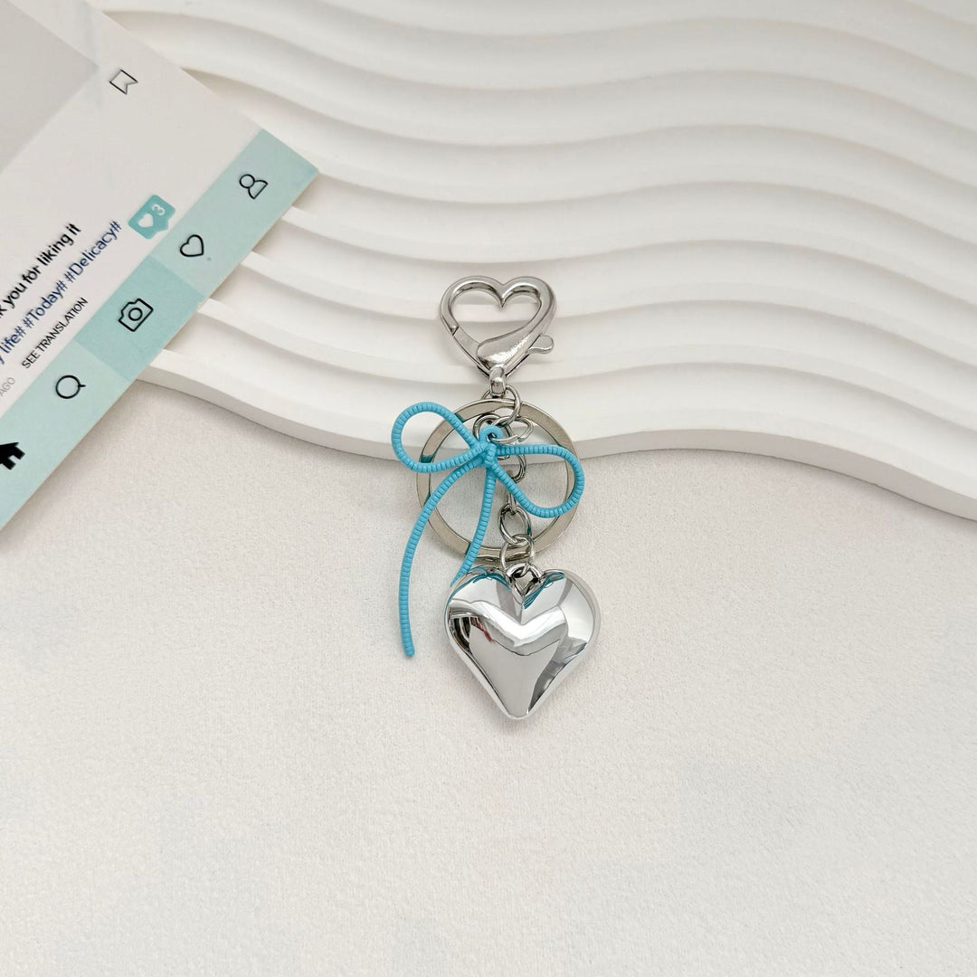Heart-Shaped Metallic Keychain with Decorative Bow Kalsten