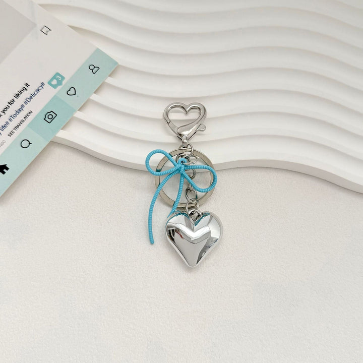 Heart-Shaped Metallic Keychain with Decorative Bow Kalsten