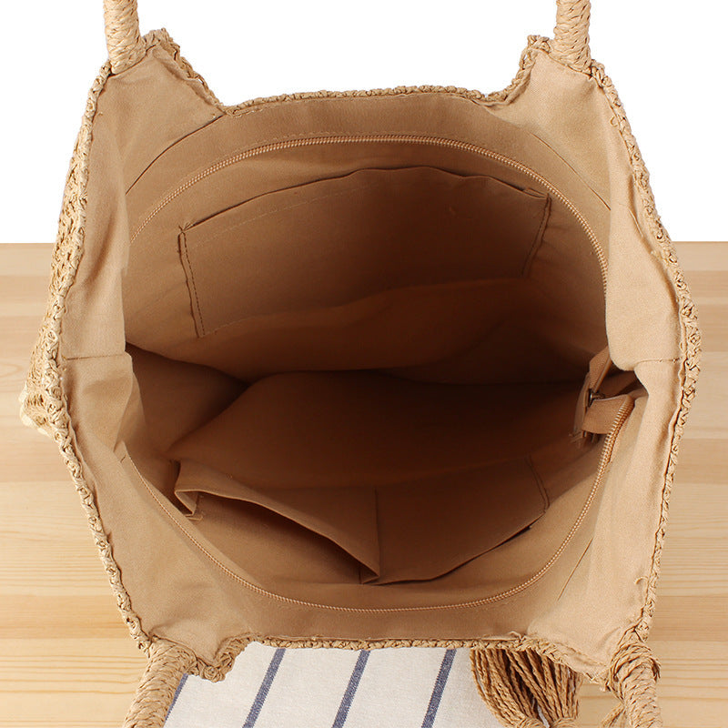 Fashionable beach tote bag made of woven natural material with fringed detail Kalsten