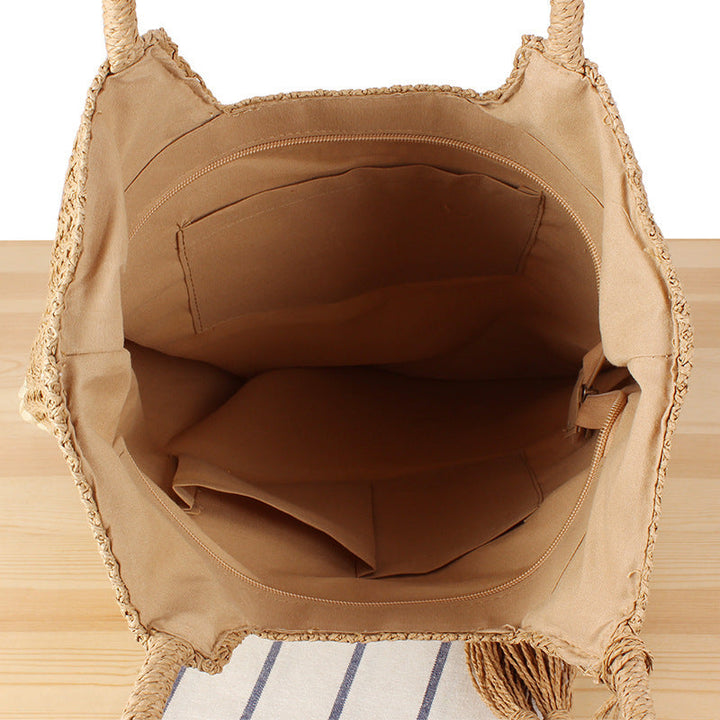 Fashionable beach tote bag made of woven natural material with fringed detail Kalsten