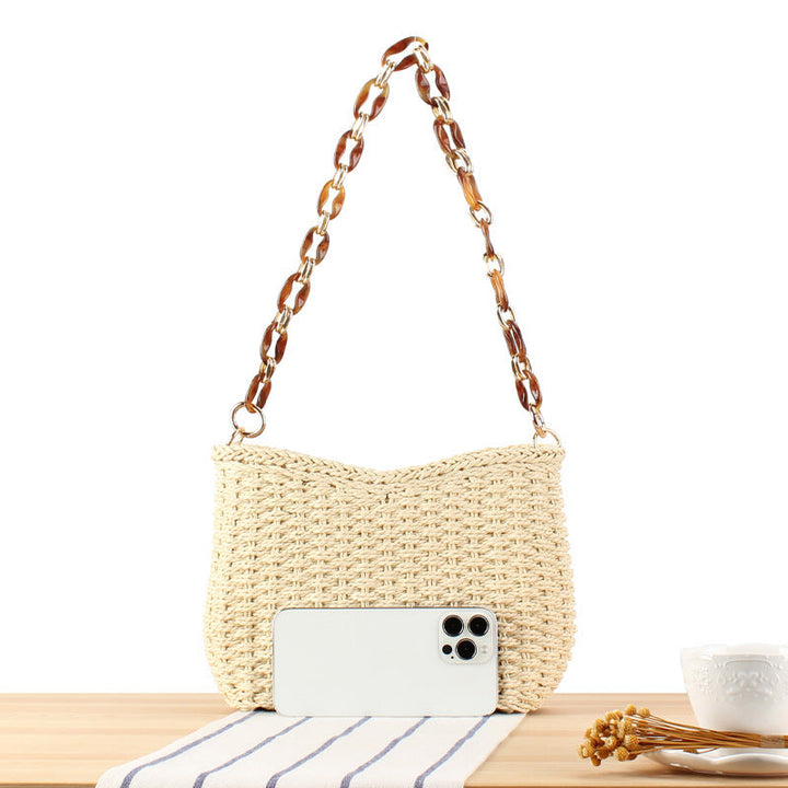 Stylish handbag made of woven natural material with exclusive chain accents Kalsten