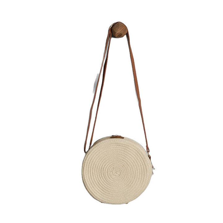 Round shoulder bag made of natural material with stylish accents Kalsten