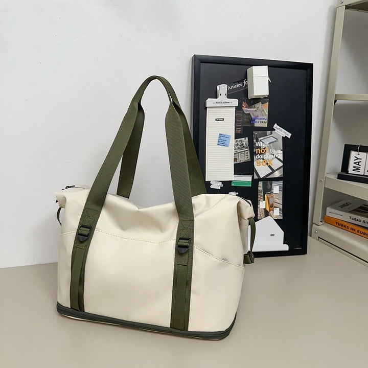 Sporty shoulder bag with water-repellent material and sturdy carrying handles Kalsten