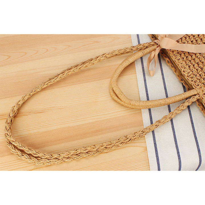 Beach bag made of natural raffia with playful design and elegant bow decoration Kalsten
