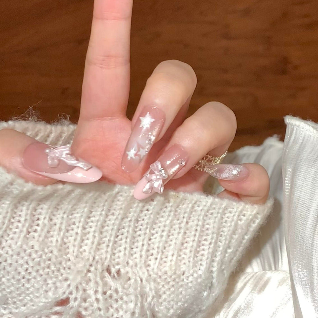 Artificial nail tips with glamorous glitter and bow details Kalsten