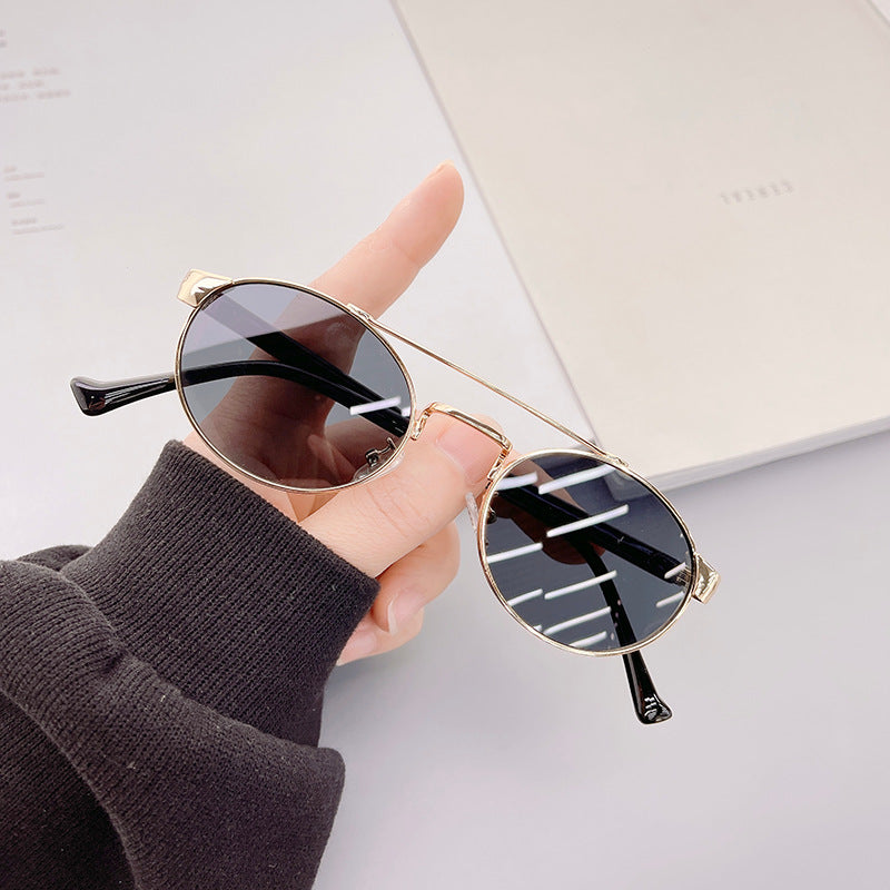 Ladies fashionable sunglasses in stylish round design with golden accents Kalsten