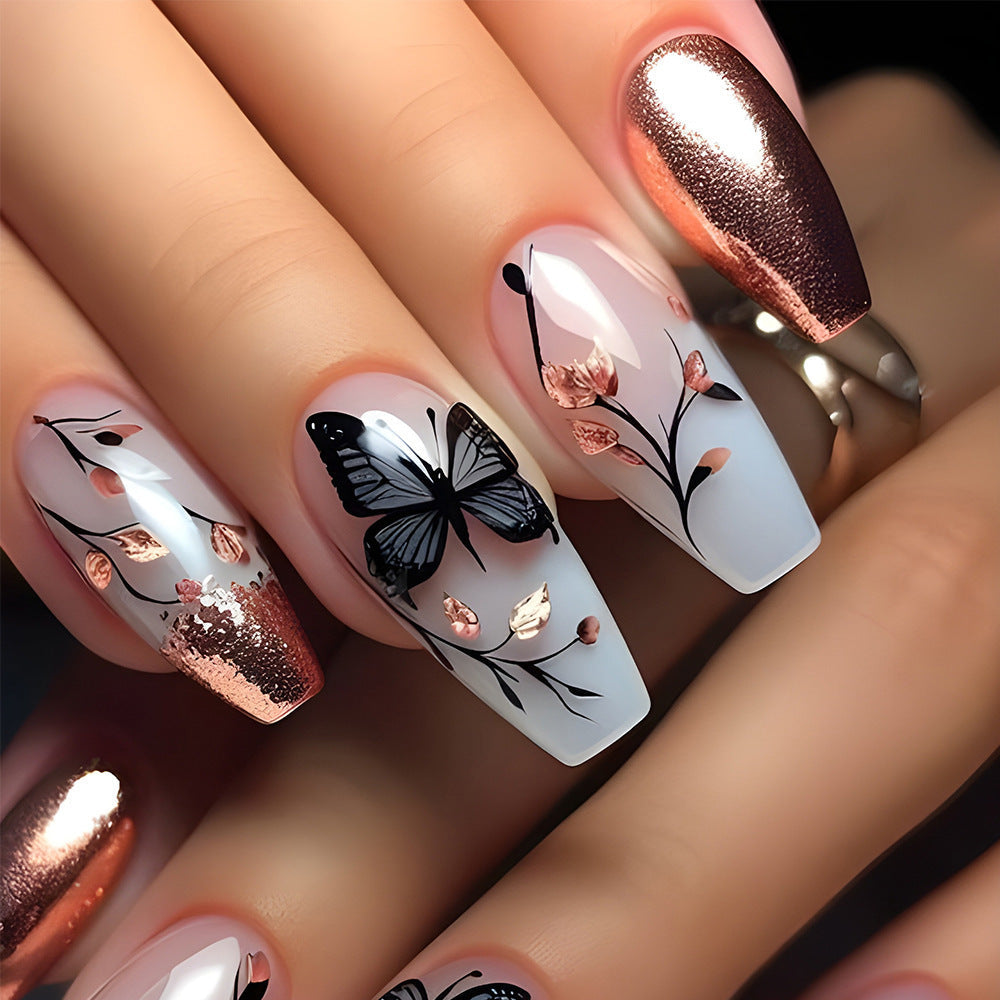 Artificial nails with filigree butterfly design and golden accents Kalsten