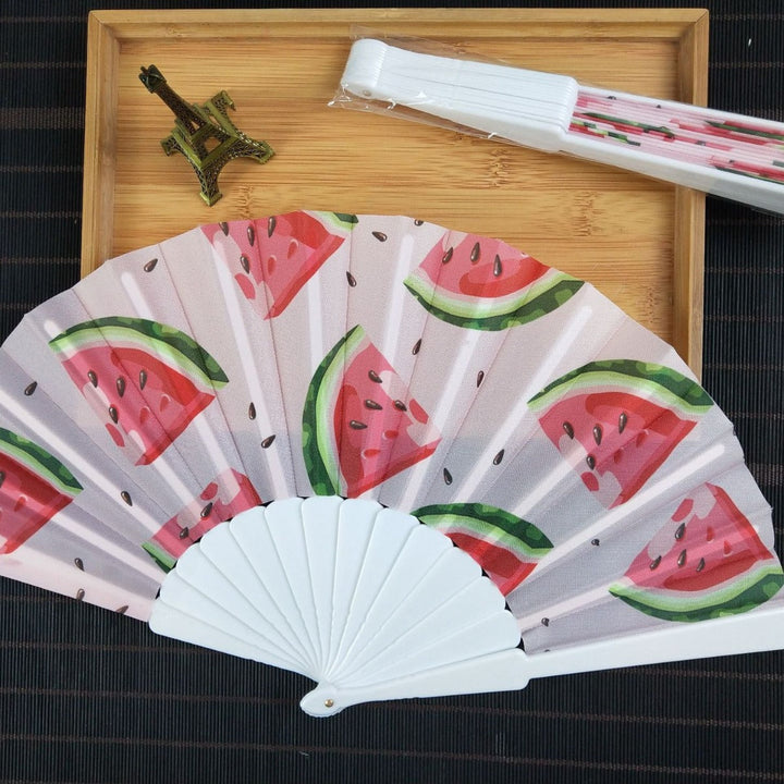 Women folding hand fan with shimmering scale pattern Kalsten