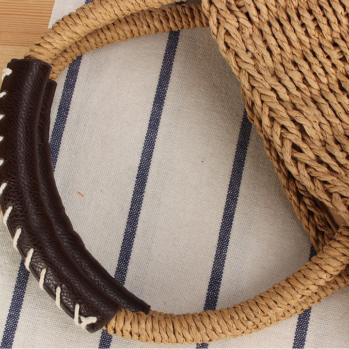 Basket bag made of woven natural material with leather handles Kalsten