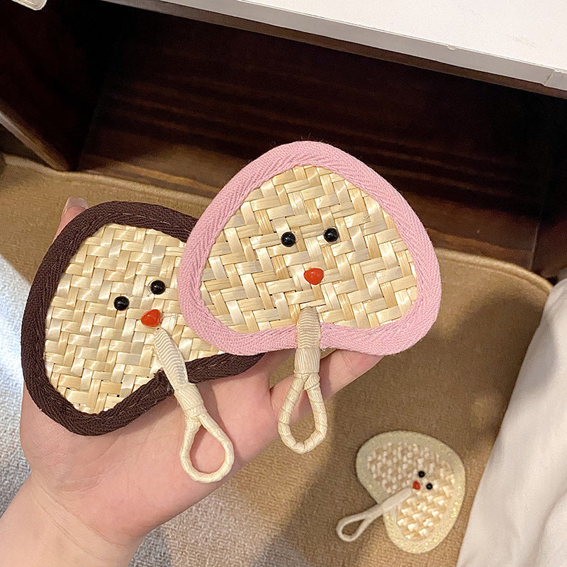 Handcrafted fan with playful face motif Kalsten
