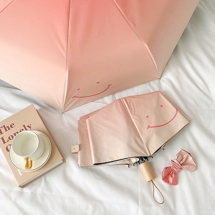 Women's foldable umbrella with playful design and handy wooden handle Kalsten