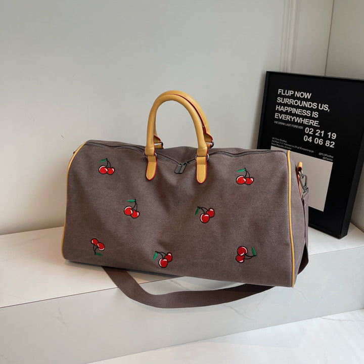 Sporty weekend bag with playful cherry pattern Kalsten