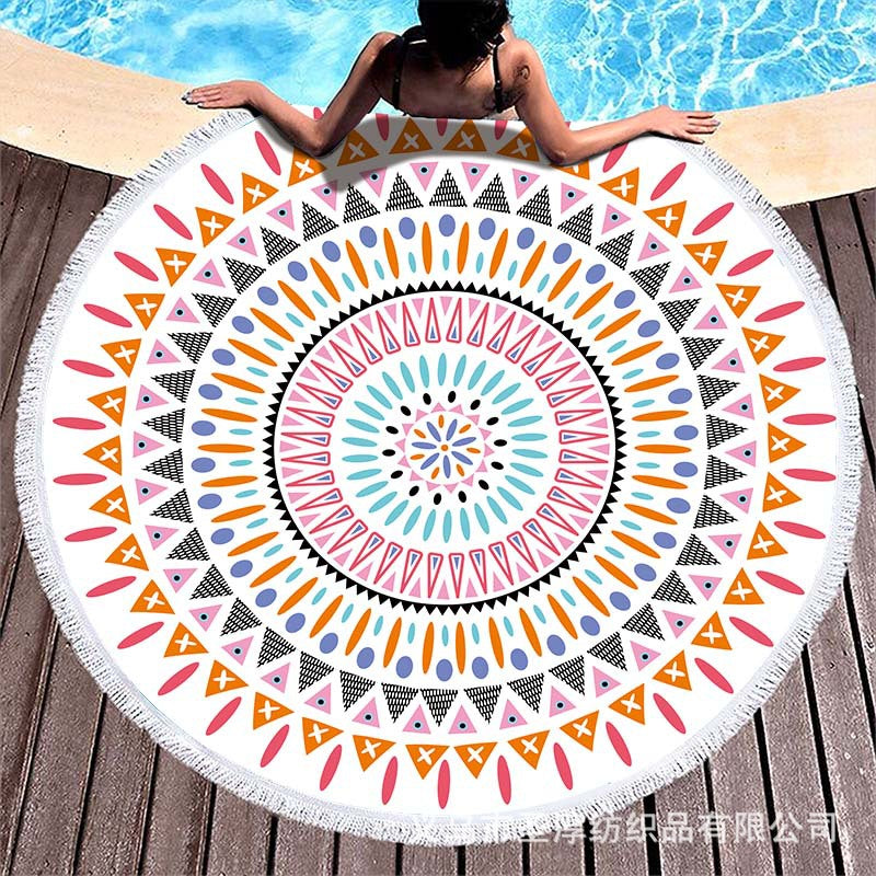 Round beach towel with colorful, tropical floral pattern and fringe decoration Kalsten