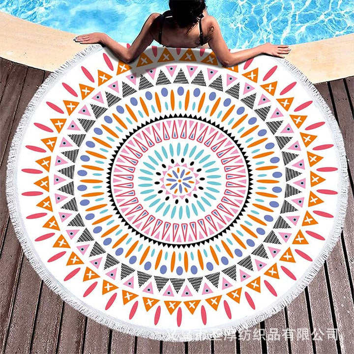 Round beach towel with colorful, tropical floral pattern and fringe decoration Kalsten