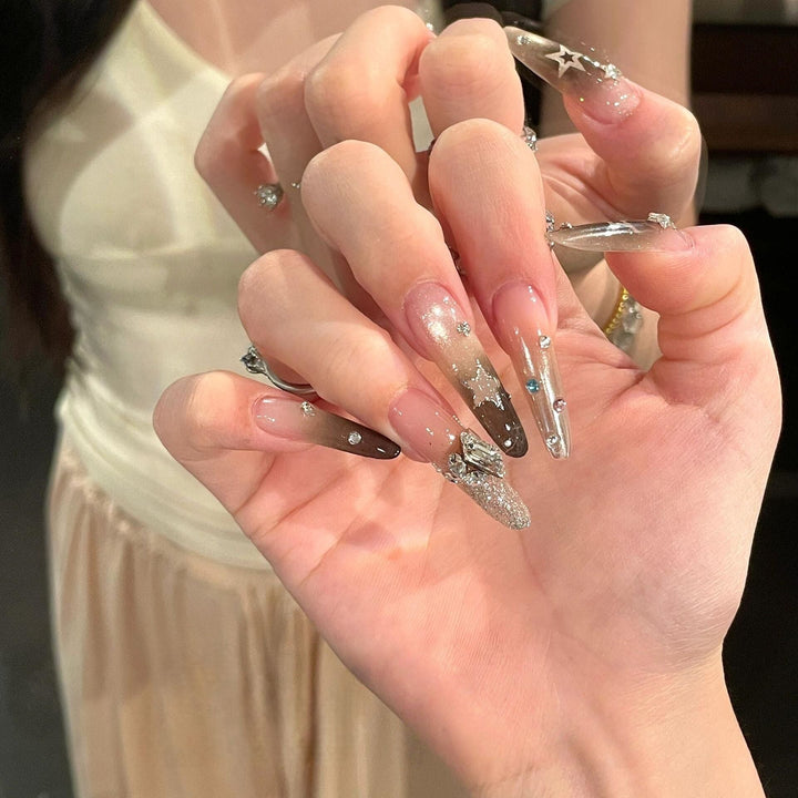 Glamorous artificial nails with sparkling rhinestone and star designs Kalsten