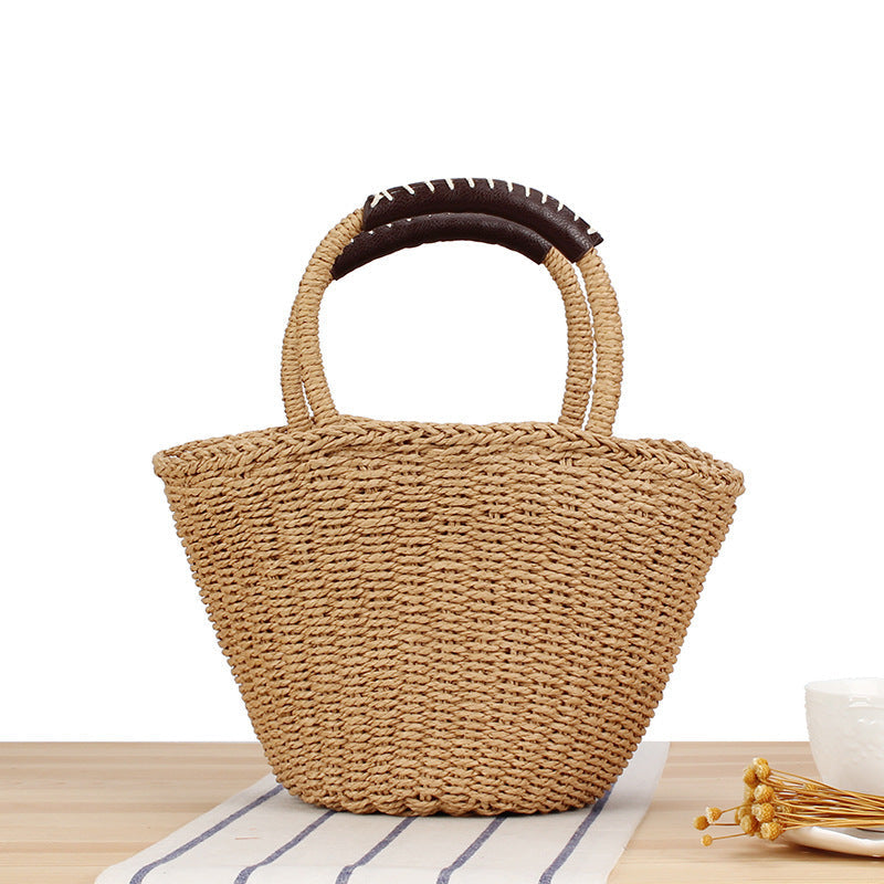 Basket bag made of woven natural material with leather handles Kalsten