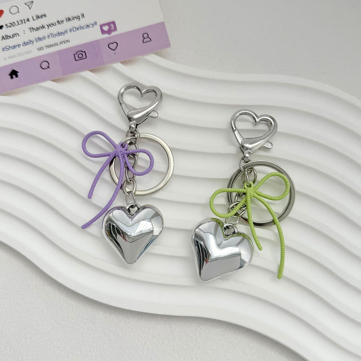 Heart-Shaped Metallic Keychain with Decorative Bow Kalsten